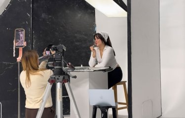 A Falmouth University student photographing another student in the studio