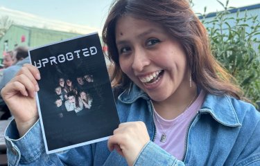 A Theatre & Performance student holding up a poster