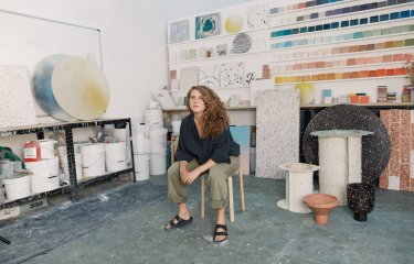 A woman sat on a chair in her studio