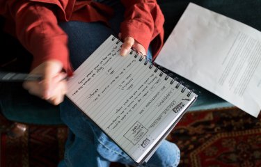 A woman writing in a notebook
