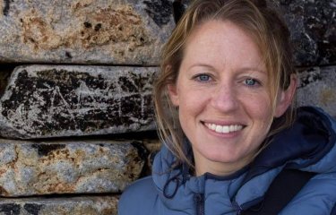 A woman smiling into the camera