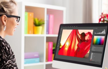 Person sat at a computer looking at photoshop