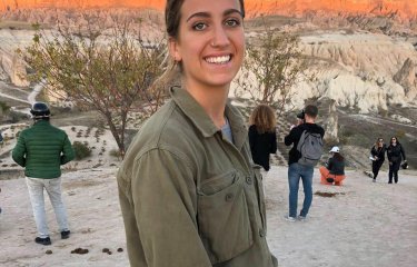 A woman smiling, wearing a green shirt