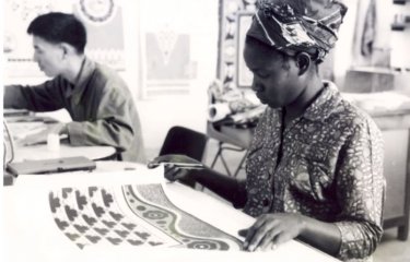 A woman examines textiles 