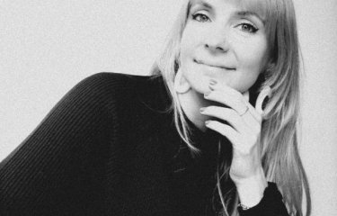 A woman looking into the camera smiling