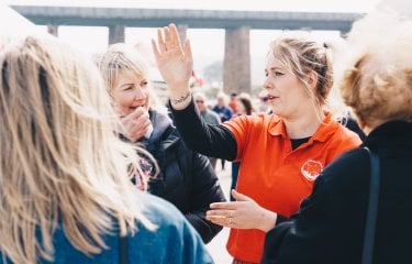 An event steward giving people directions