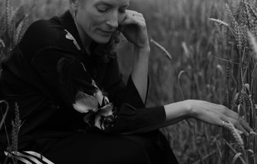 A woman sat in a field 