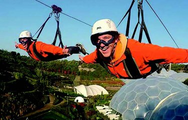 Two people on a zip line above The Eden Project