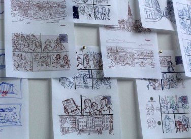 A selection of drawings on paper pinned to a wall