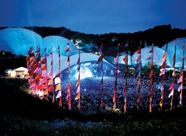 Music festival at the Eden Project with domes and pink flags