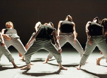 Dance students arching bodies backwards