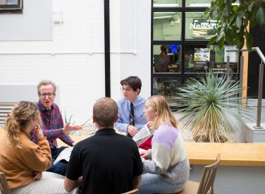 Journalism students sitting in a circle