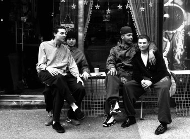 Four people sitting outside a cafe on Brick Lane photo by Alice McDonald