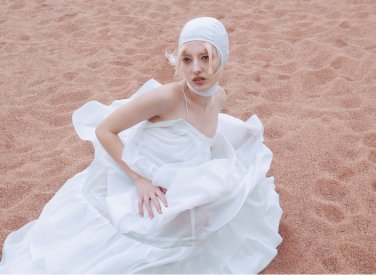 Model in white dress on beach