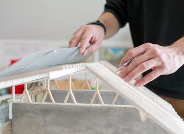 Hands holding an architectural model