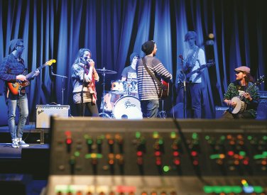 Band on a stage warming up with blue lighting