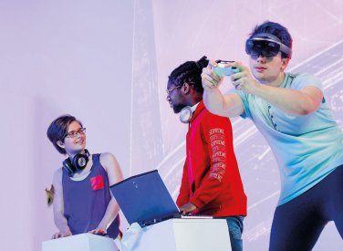 Student with VR set and hand controller