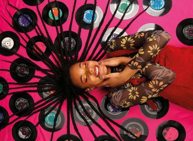 Model lying on records with hair spread out over them
