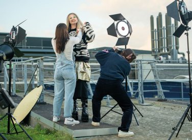 Students styling fashion shoot on rooftop