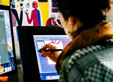 Visual Communication student drawing on a tablet