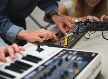 Close up of hands on keyboard and mixer