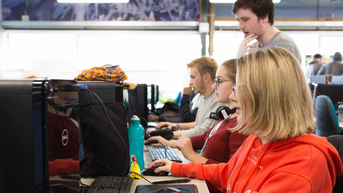 Falmouth University students sitting at computers working together