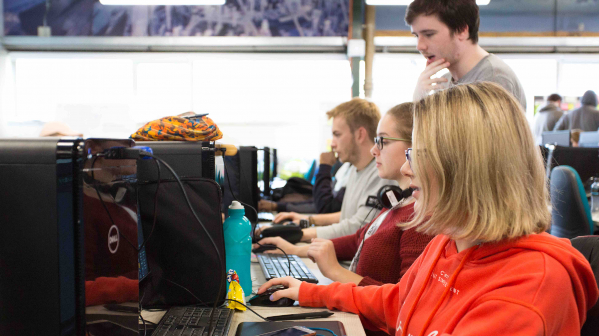Students sitting at computers working together Falmouth University students sitting at computers working together