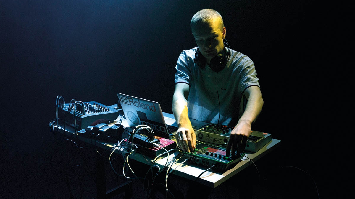Student at mixing deck adjusting controls