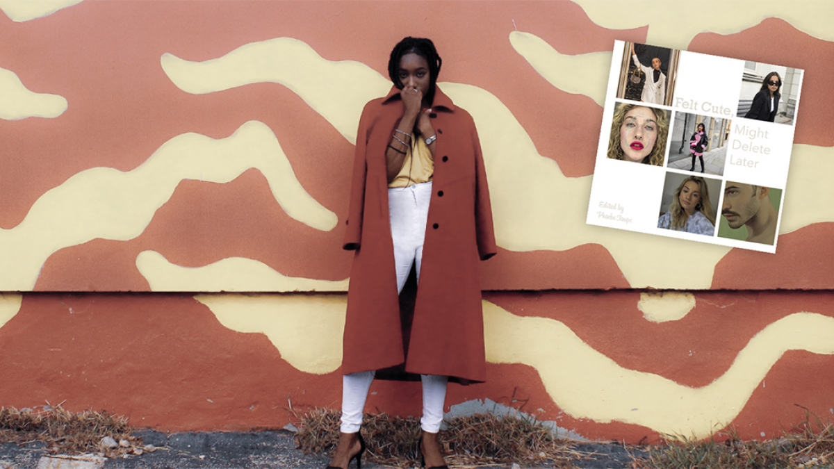 A woman in a red coat in front of a yellow and red wall
