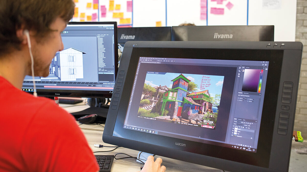 Games student working on digital game artwork on a screen.
