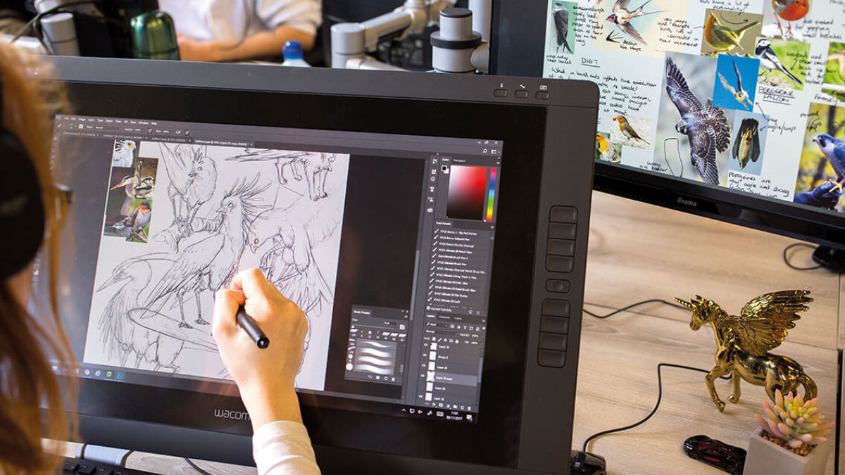 A Game Art student drawing birds on a digital screen