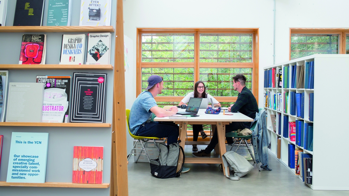 Graphic Design Students in Shared Work Space Graphic Design students collaborating in shared work space
