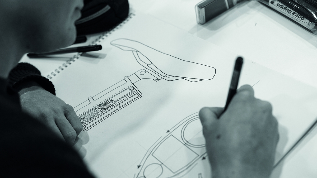 Student drawing design for a bike seat.
