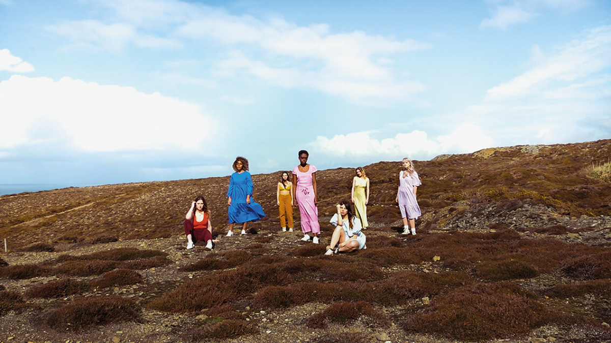 A group of Popular Music students posting on a barren landscape