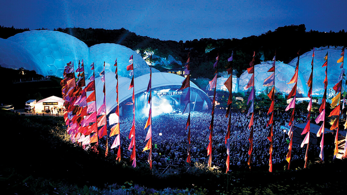 Music festival at the Eden Project with domes and pink flags