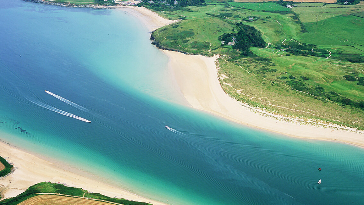 Aerial view of an estuary with sandy beaches and fields