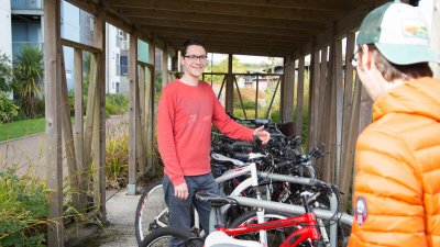 Students chatting in bike store on Penryn Campus