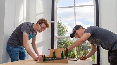 Two Falmouth University Architecture students examining model
