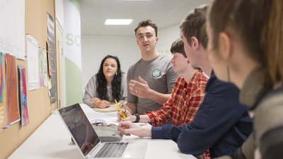Falmouth University Entrepreneurship students in the studio with a laptop