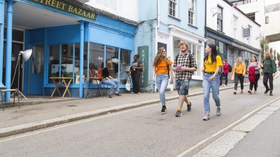 Three students walking down Falmouth high street