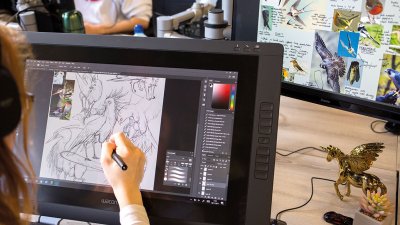 A Game Art student drawing birds on a digital screen