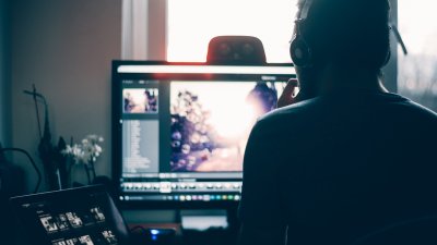 Student working on Premier Pro on a desktop.