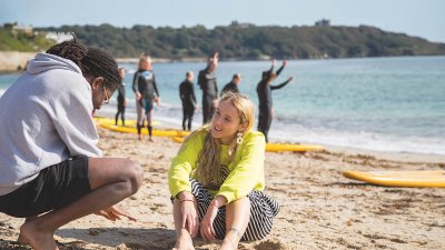 Two students talking on the beach in Falmouth