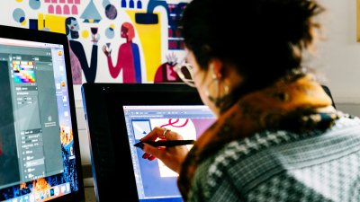Female student drawing on a digital screen
