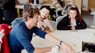 Staff and students talking around a table