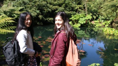 Falmouth international students standing next to pond.