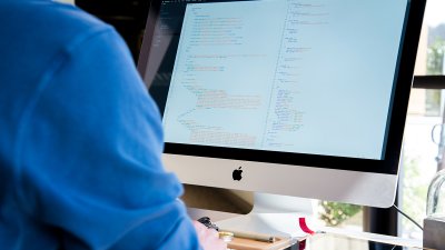 Student looking at code on an iMac.