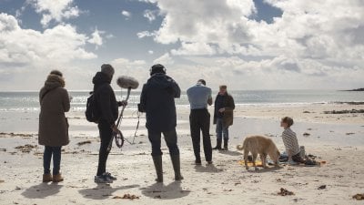 Falmouth University student film crew on beach location.
