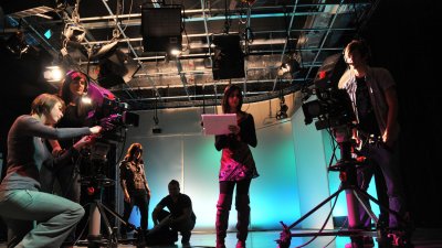 Falmouth University students in a film studio working with television cameras.