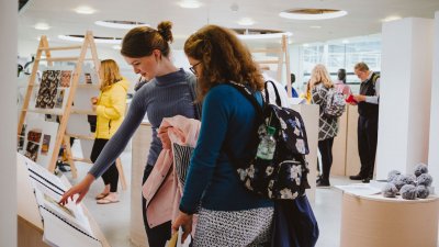 Mother and daughter at a Falmouth University open day looking at art work.
